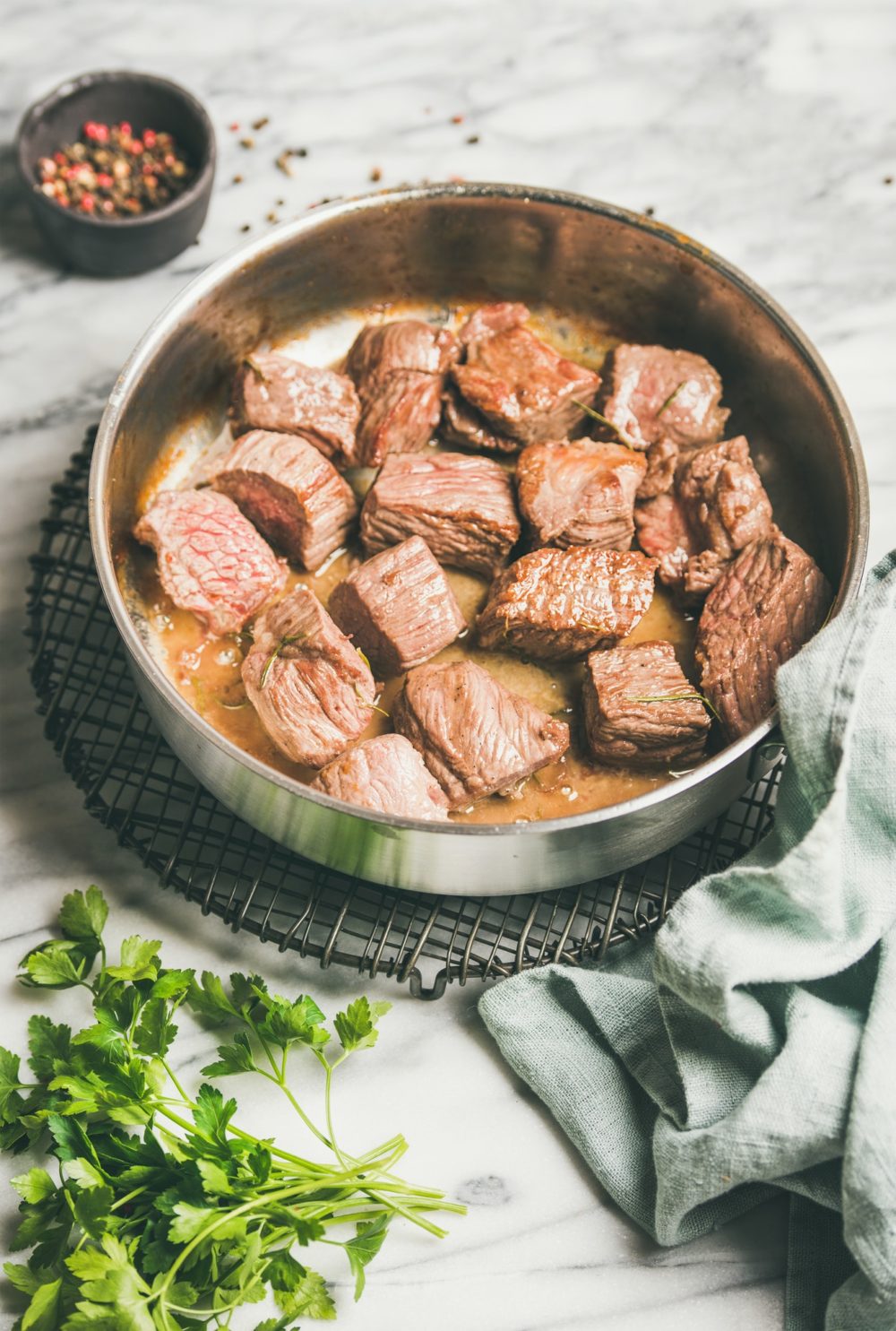 Braised beef meat stew with fresh parsley in pan