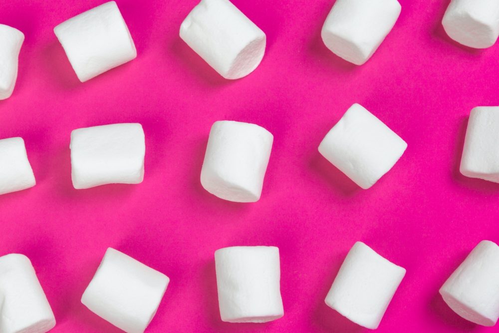marshmallows on a pink background. top view