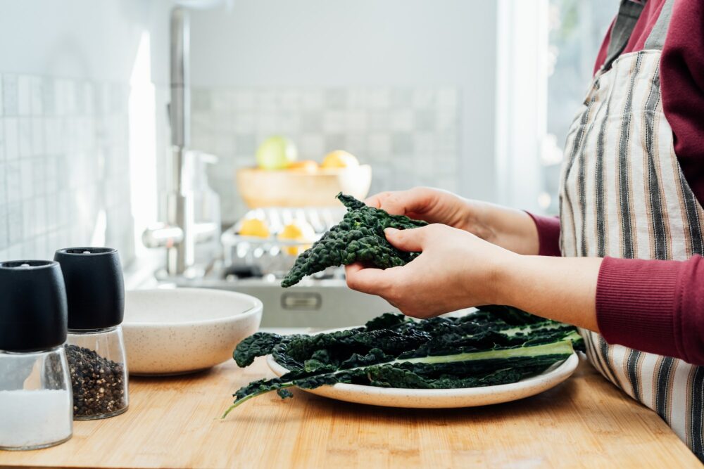 Woman cooking kale. Healthy eating