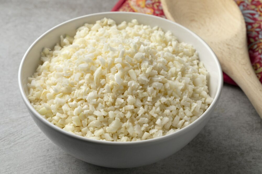Bowl with fresh cut cauliflower rice close up
