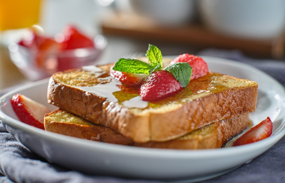 french toast with strawberries and syrup